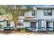 Close-up of a two-story townhome featuring a well-maintained lawn and a classic facade at 2722 Graduate Ct, Orlando, FL 32826