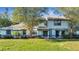 Charming townhome featuring a well-maintained lawn, mature trees, and a classic two-story facade at 2722 Graduate Ct, Orlando, FL 32826