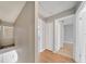 Upstairs hallway featuring hardwood flooring and a view of several bedroom doors at 2722 Graduate Ct, Orlando, FL 32826