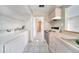 Clean kitchen featuring a double sink, ample cabinets, stove top and a laundry area at 2722 Graduate Ct, Orlando, FL 32826