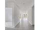 Bright hallway with neutral colors, tile flooring, and a view into the well-lit rooms, providing a sense of openness at 349 River Front Way, Edgewater, FL 32141