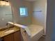 Bathroom with soaking tub, granite countertop vanity, and lots of natural light at 806 Grantham Dr, Kissimmee, FL 34758