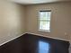 Cozy bedroom with wood floors and window providing natural light at 806 Grantham Dr, Kissimmee, FL 34758