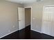 Bedroom with wood floors, star accents, closet, and a door leading to the rest of the house at 806 Grantham Dr, Kissimmee, FL 34758