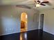 Spacious main bedroom features wood floors and an arched doorway to an en-suite bathroom at 806 Grantham Dr, Kissimmee, FL 34758