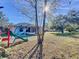 Large backyard with playset and mature trees at 4490 Treasure Cay Rd, Tavares, FL 32778