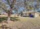 Spacious backyard with large tree and patio at 4490 Treasure Cay Rd, Tavares, FL 32778