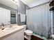 Clean bathroom with shower/tub combo, vanity, and patterned shower curtain at 4490 Treasure Cay Rd, Tavares, FL 32778