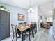 Charming dining room with a wooden table and gray floors at 4490 Treasure Cay Rd, Tavares, FL 32778