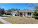 Single-story house with a white garage door and a manicured lawn at 4490 Treasure Cay Rd, Tavares, FL 32778