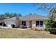 One-story house featuring a white garage door and well-maintained yard at 4490 Treasure Cay Rd, Tavares, FL 32778