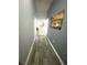 Bright hallway with gray walls, wood-look flooring, and tasteful decor at 4490 Treasure Cay Rd, Tavares, FL 32778