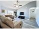 Spacious living room with gray walls and vinyl plank floors at 4490 Treasure Cay Rd, Tavares, FL 32778