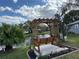 Charming backyard with wooden swing and water view for serene relaxation at 4901 Pleasant Hollow Trl, Lakeland, FL 33811