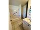 Functional bathroom featuring tile flooring, a tub with shower, a toilet, and a single sink vanity at 4901 Pleasant Hollow Trl, Lakeland, FL 33811