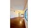 Inviting living room with shiny hardwood floors, white walls and a view into the kitchen at 4901 Pleasant Hollow Trl, Lakeland, FL 33811