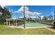 Active shuffleboard court area with covered seating and lush landscaping for leisure activities at 4901 Pleasant Hollow Trl, Lakeland, FL 33811