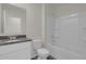 Clean bathroom with granite vanity, white cabinets, and a bathtub at 957 King Parc Rd, Orange City, FL 32763