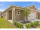 Charming one-story home featuring a covered porch, attached garage, and beautifully landscaped front yard at 957 King Parc Rd, Orange City, FL 32763