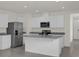 Open kitchen with white cabinets and granite countertops at 957 King Parc Rd, Orange City, FL 32763