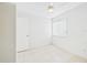 Bedroom features neutral tile flooring, a ceiling fan, closet and a window for natural light at 2409 Atrium Cir, Orlando, FL 32808