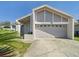 Charming home featuring an attached garage, neutral stucco exterior, and well-maintained driveway at 2409 Atrium Cir, Orlando, FL 32808