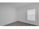 A bright, carpeted bedroom with a window, offering ample natural light and a cozy feel at 4939 Worchester Dr, Kissimmee, FL 34746