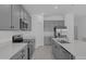 Modern kitchen with stainless steel appliances, white countertops and gray cabinets at 4939 Worchester Dr, Kissimmee, FL 34746