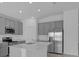 Modern kitchen with stainless steel appliances, white countertops and gray cabinets at 4939 Worchester Dr, Kissimmee, FL 34746