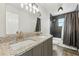 Bathroom featuring double sinks, granite countertops, and a tiled shower with a glass door at 724 Tahiti Dr, Kissimmee, FL 34758