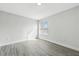 Well-lit bedroom with wood floors, neutral paint, and a large window at 724 Tahiti Dr, Kissimmee, FL 34758