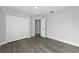 Clean bedroom featuring wood floors, closet, and neutral paint at 724 Tahiti Dr, Kissimmee, FL 34758
