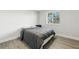 Cozy bedroom with wood-look flooring and a large window providing natural light at 724 Tahiti Dr, Kissimmee, FL 34758
