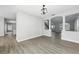 Open dining room with new light gray floors and columned archway to the entry at 724 Tahiti Dr, Kissimmee, FL 34758