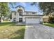 Charming two-story home with a well-maintained lawn, attached two car garage, and beautiful curb appeal at 724 Tahiti Dr, Kissimmee, FL 34758