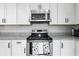 Well-lit kitchen area featuring stainless steel appliances, white cabinets, and granite countertops at 724 Tahiti Dr, Kissimmee, FL 34758
