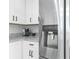 Close up of kitchen counter, cabinets, and stainless steel refrigerator with water dispenser at 724 Tahiti Dr, Kissimmee, FL 34758