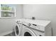 Convenient laundry room with modern, front-loading washer and dryer at 724 Tahiti Dr, Kissimmee, FL 34758