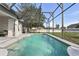 Relaxing screened-in pool with spacious deck and lush landscaping at 724 Tahiti Dr, Kissimmee, FL 34758