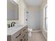 Modern bathroom features a wood vanity with white countertop and a walk-in shower at 7801 Belvoir Dr, Orlando, FL 32835
