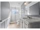 Bathroom featuring marble vanity, tiled shower, and stylish fixtures at 7801 Belvoir Dr, Orlando, FL 32835