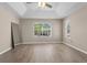 Bright bedroom with wood floors, large windows, and a modern ceiling fan at 7801 Belvoir Dr, Orlando, FL 32835