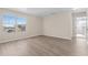 Bright bedroom featuring wood-look flooring, a large window, and neutral paint at 7801 Belvoir Dr, Orlando, FL 32835