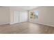 Inviting bedroom with wood-look floors, double closet, and bright window at 7801 Belvoir Dr, Orlando, FL 32835