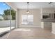 Bright dining area with sliding glass doors, complemented by wood-look tile flooring and recessed lighting at 7801 Belvoir Dr, Orlando, FL 32835