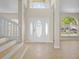 Bright foyer with a decorative front door, wood flooring, and ample natural light from large windows at 7801 Belvoir Dr, Orlando, FL 32835