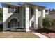 Charming home featuring stately columns, a manicured lawn, and a welcoming brick pathway at 7801 Belvoir Dr, Orlando, FL 32835