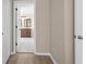 Hallway view of bathroom vanity with wood cabinets and light countertops at 7801 Belvoir Dr, Orlando, FL 32835