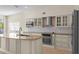 Well-appointed kitchen featuring granite countertops, stainless steel appliances, and bright white cabinets at 7801 Belvoir Dr, Orlando, FL 32835