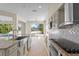 Gourmet kitchen with stainless steel appliances, granite countertops, and backyard views overlooking the pool area at 7801 Belvoir Dr, Orlando, FL 32835
